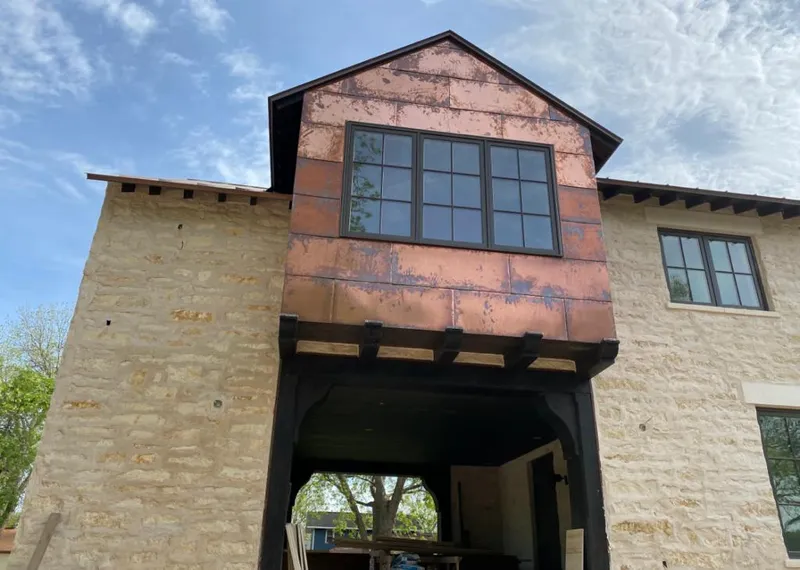 Copper metal panel facade on a stone building for Roof Repair in DeRidder